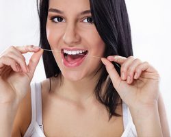 Woman Flossing her Teeth | Decay Prevention | Alluring Smiles in Mesa, AZ - Dr. Javier Portocarrero