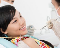 Smiling Young Girl on a Dental Chair | Dental Emergencies | Alluring Smiles in Mesa, AZ - Dr. Javier Portocarrero